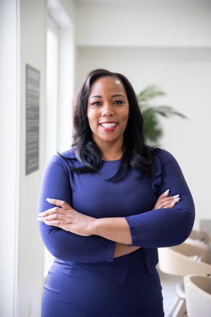 Professional training and development consultant standing confidently in a navy blue dress
